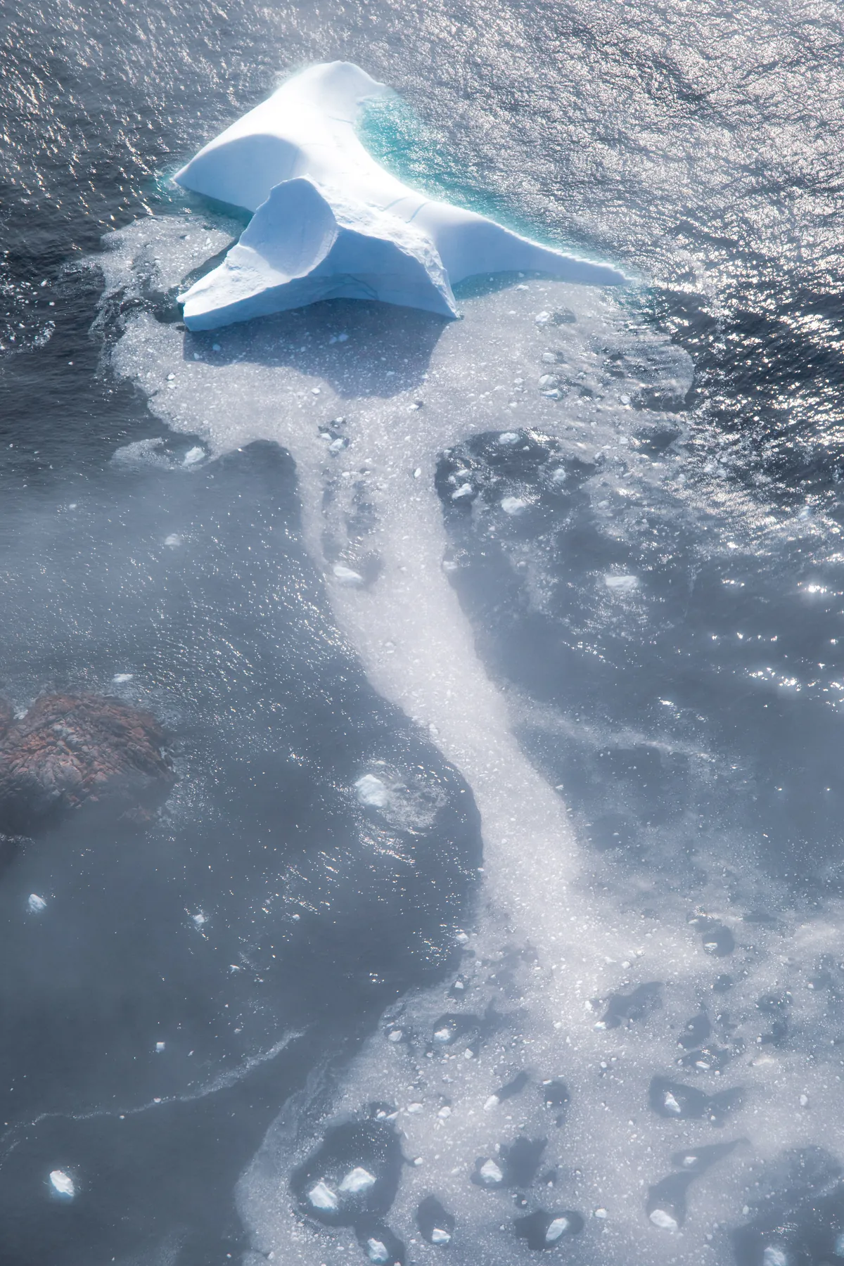 Eisberg im dunklen Wasser aus der Vogelperspektive – Grönland